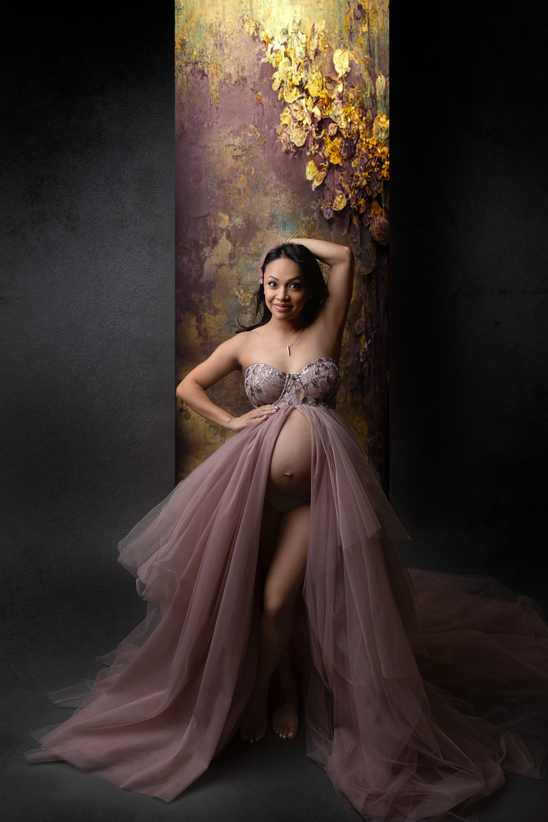 Maternity pictures using a purple gown with golden backdrop