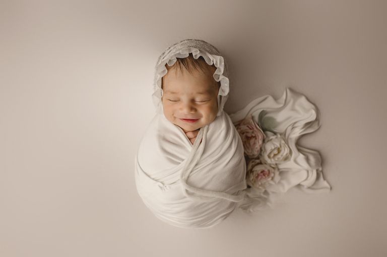 newborn baby safely supported with proper head and neck positioning