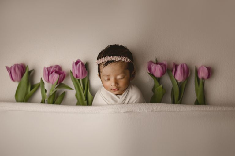 Fine-art newborn portrait preserving a baby’s earliest days with warmth and care