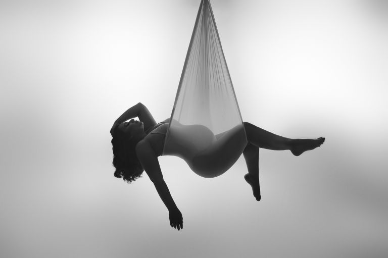 Celebrate motherhood with an elegant maternity sling photo session. Our Flower Mound studio offers luxury portraits for discerning Dallas clients