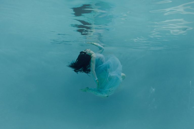underwater photography Dallas women touches the surface