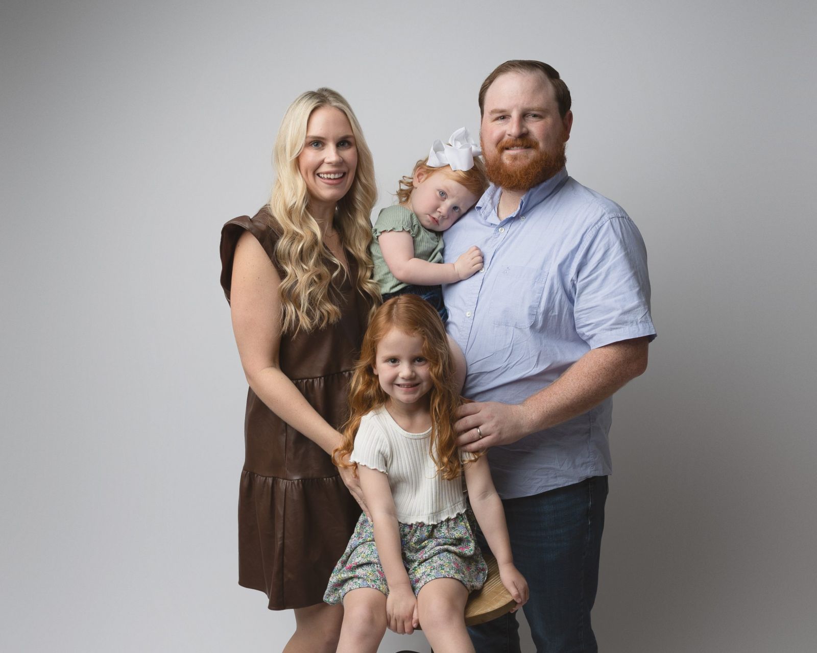 Family of four portrait captured in a fine art photography studio